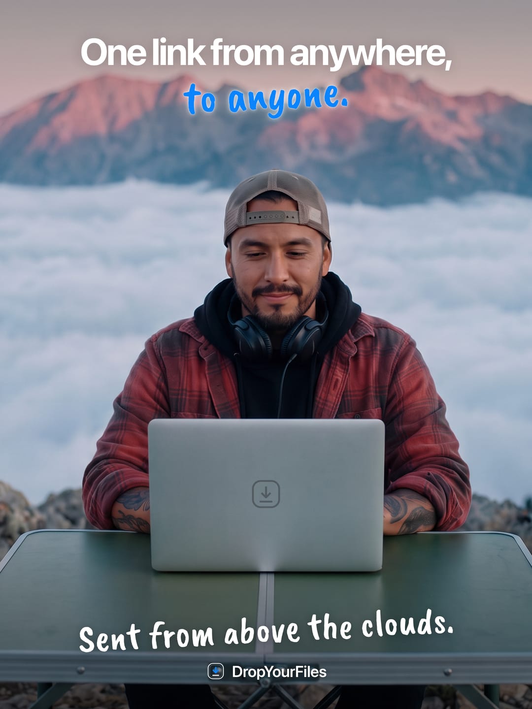 A man in a red flannel shirt at a laptop on a mountaintop above the clouds. The headline reads “One link from anywhere, to anyone.” and the line at the foot, “Sent from above the clouds.”